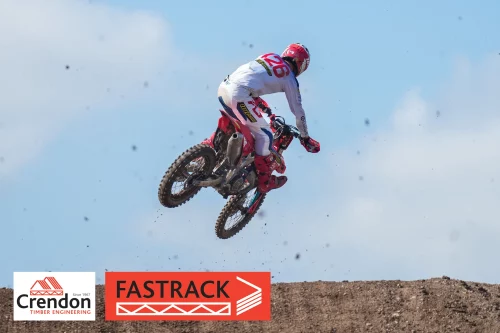 Man on his dirt bike in the air on a jump