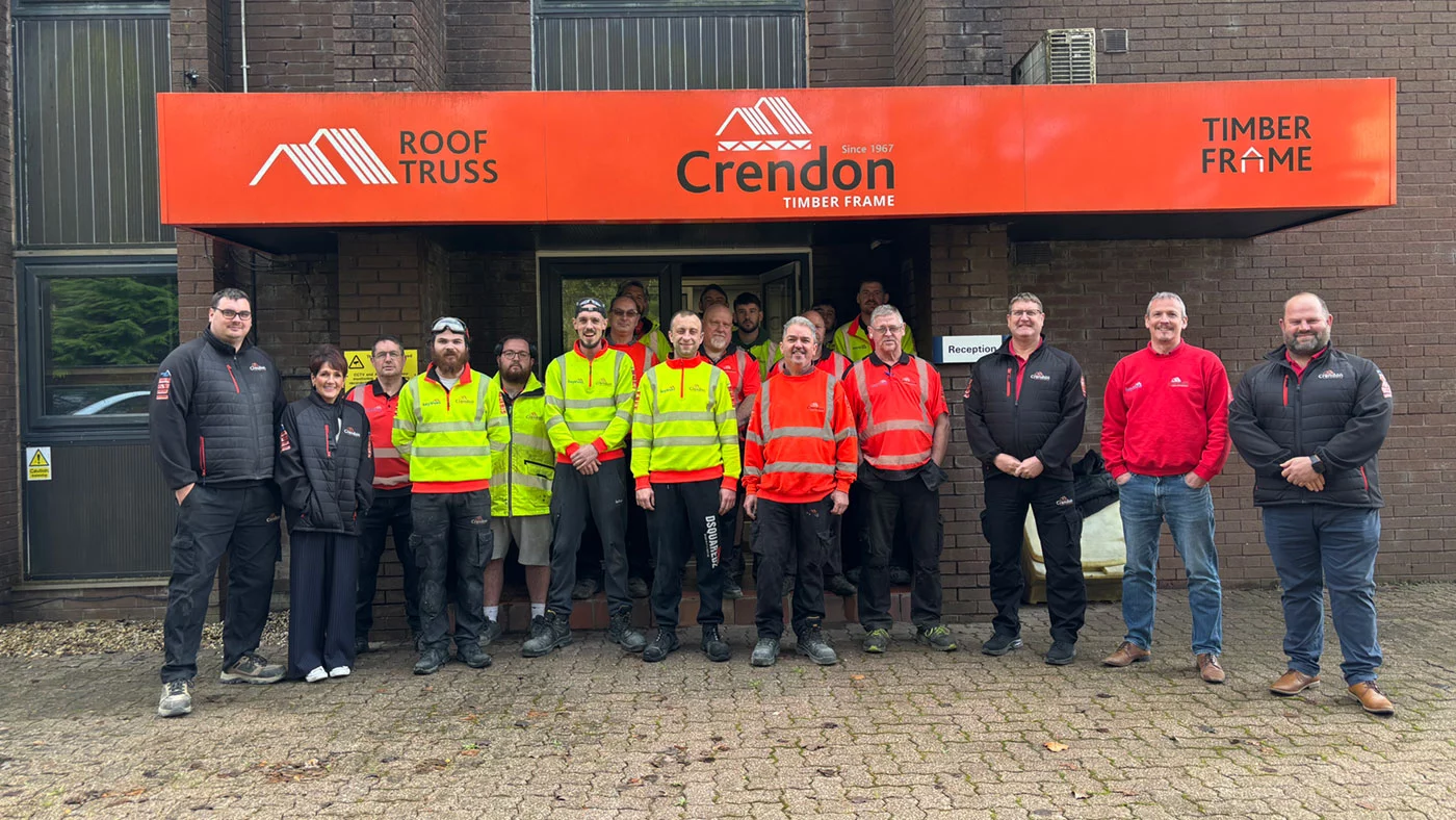 People posing for photo outside office building
