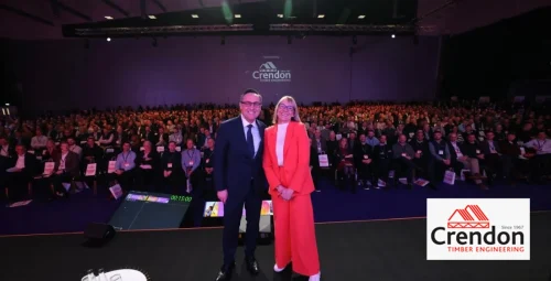 Two people posing on the stage with the Crendon logo in the background.